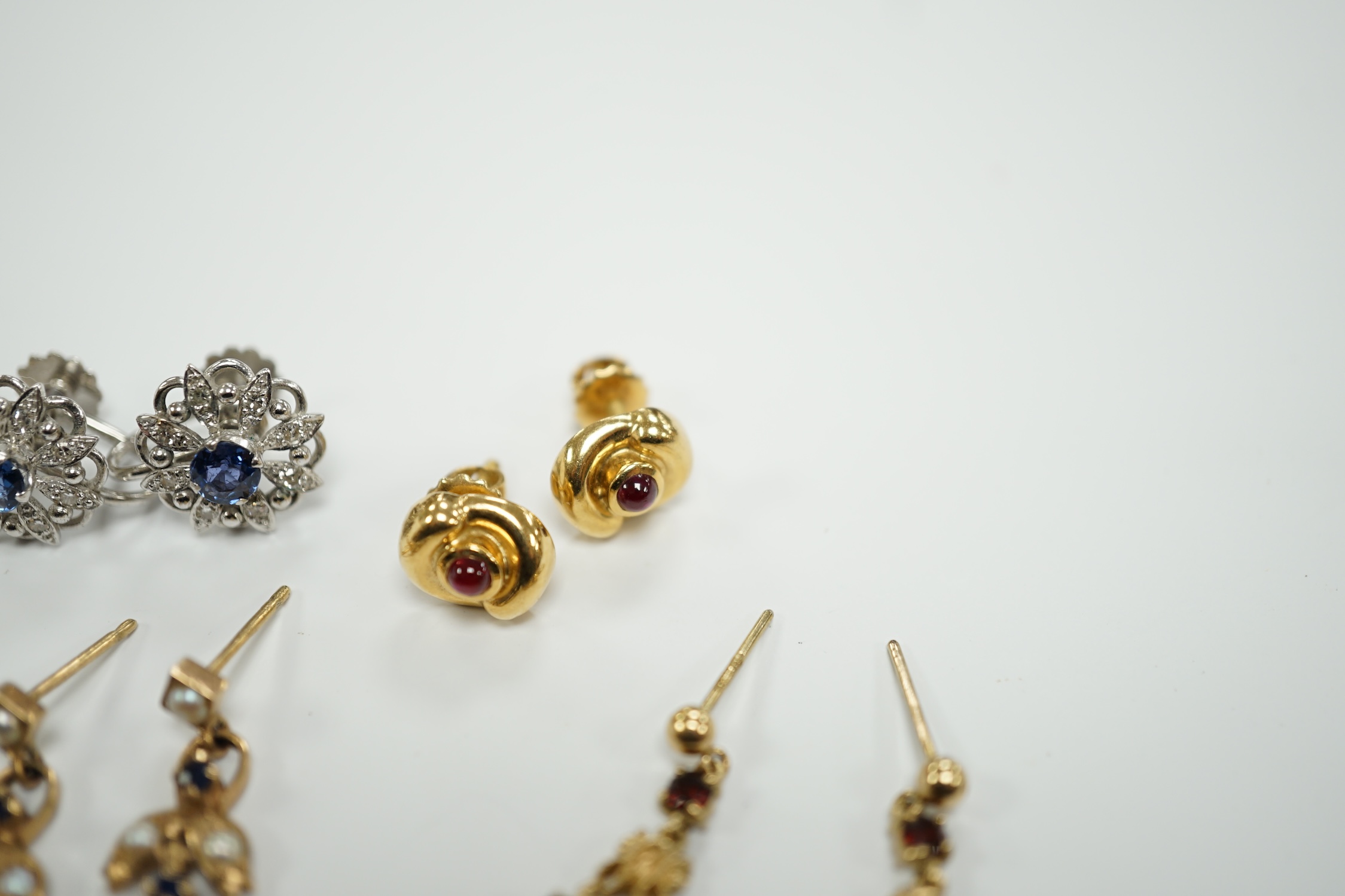 Three pairs of assorted 9ct gold earrings including two gem set, a pair of white metal (stamped 18) and gem set ear clips and a pair of 18k and cabochon ruby ear studs.
